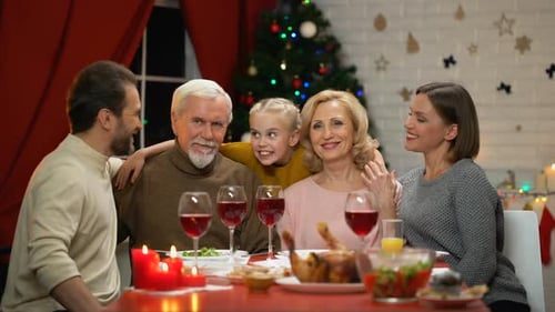 The family leans in together, all smiles.