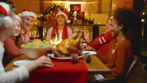 A crowded dinner table, everyone talking and laughing.