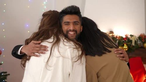 Friends arrive and hug at the party.
