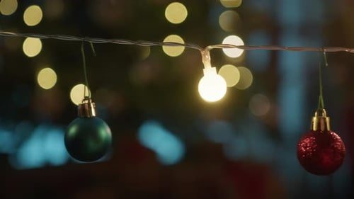 Warm string lights and ornaments glowing, the camera rising along them.