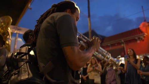 Trumpet player from below, crowd around him.