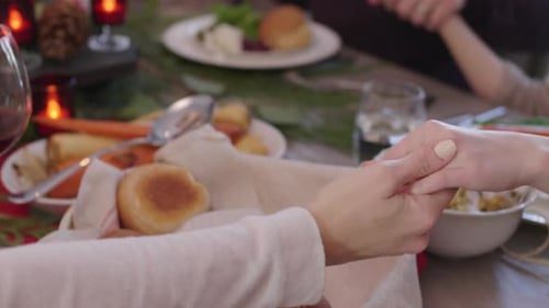 Hands joined around the table, then the family.