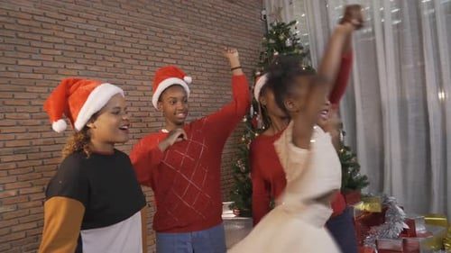 The family dancing in Santa hats.