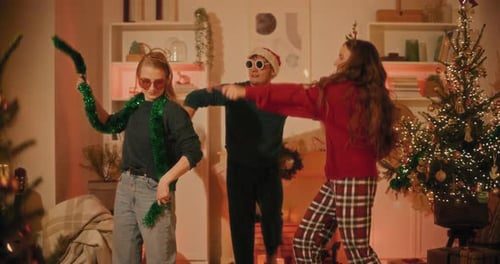 Friends dancing by the tree.