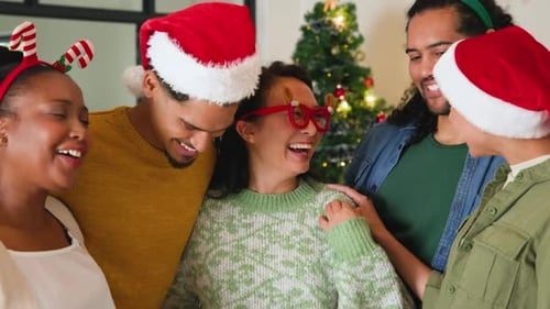 Friends laughing out loud together by the tree.