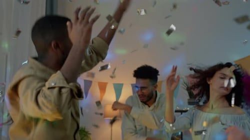 Hands up under the confetti.