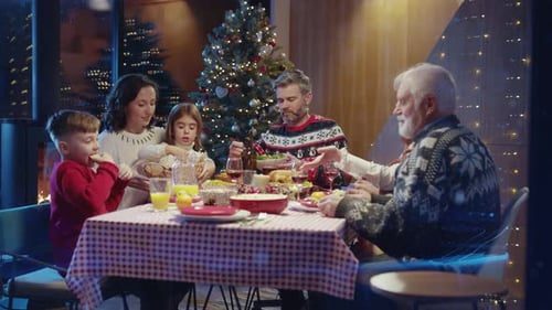Grandparents, parents and kids at dinner by the tree.