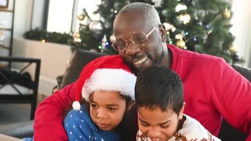 Grandpa hugs his grandkids.