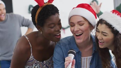 Three friends singing into one microphone.