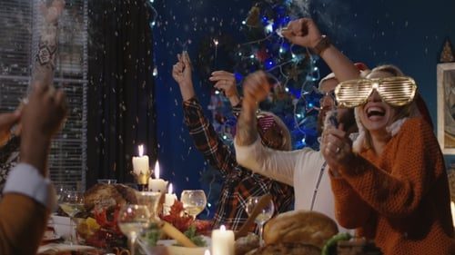 The table cheering, glasses up.