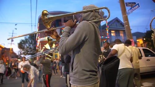 Brass band on a New Orleans street at dusk.