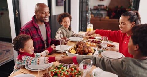 A family passing dishes around the table.