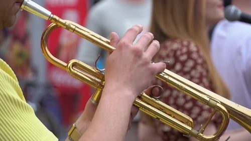 A trumpet player with the band, close.