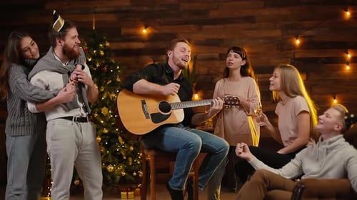 Friends singing with a guitar.